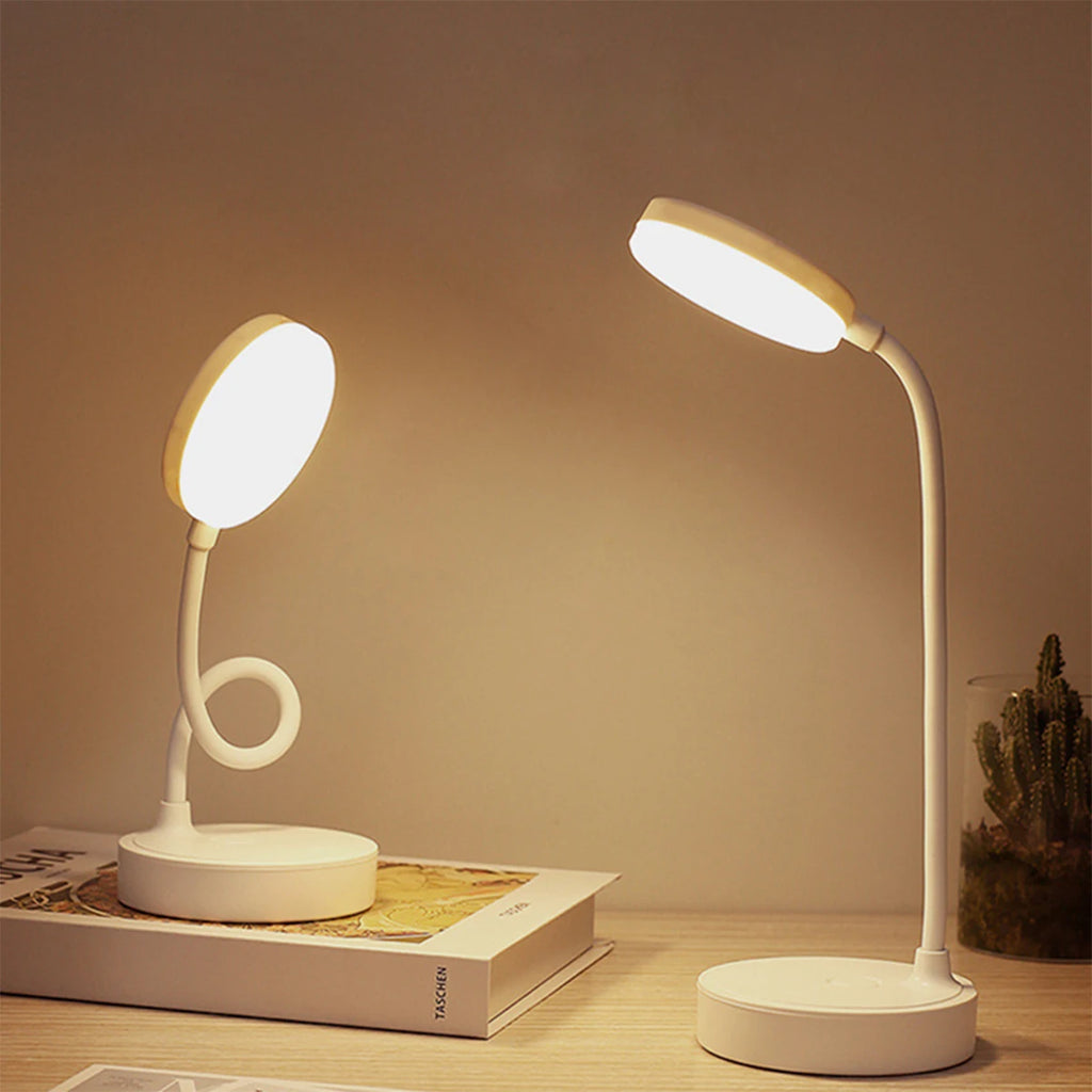 Two white LED desk lamps on a wooden surface with a warm glow.