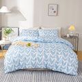 Blue and white heart-patterned bedding set on a bed in a bedroom.