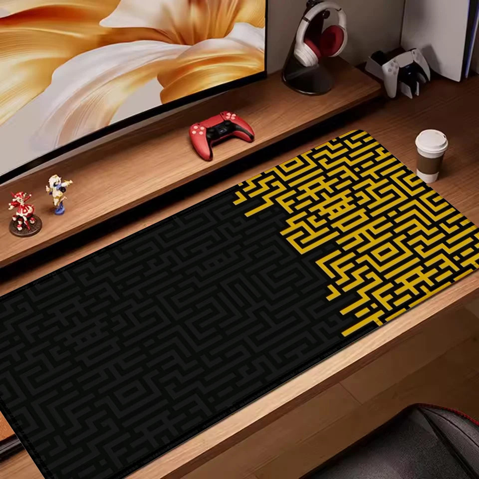 Black desk mat with bold gold maze pattern and graphic contrast