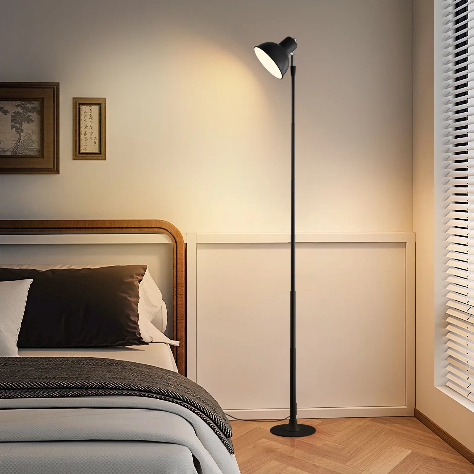 Floor lamp in a bedroom setting with a bed and wall art.