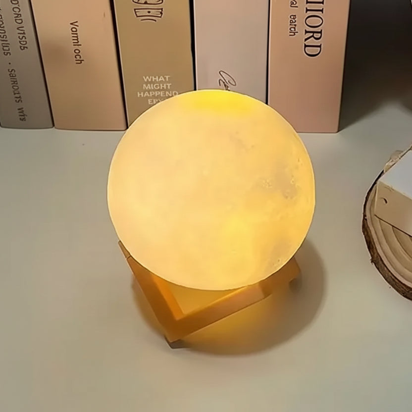 Moon shaped night light on a surface with books in the background
