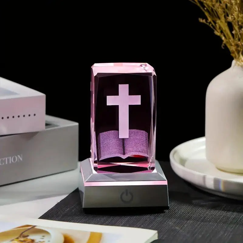 Crystal paperweight with cross design on a dark surface