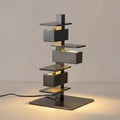 Gun black geometric table lamp with stacked metal design, 46cm height and 25cm base