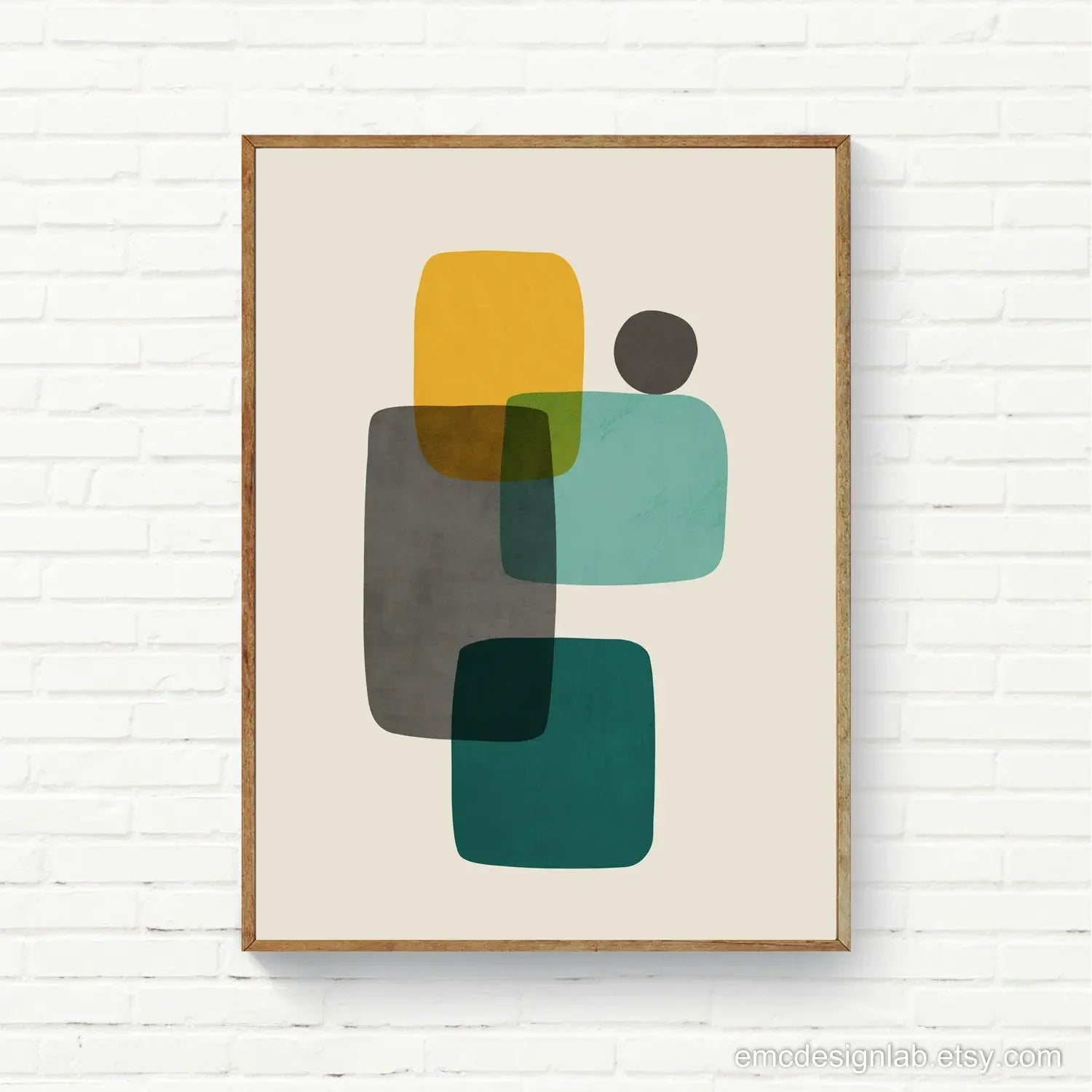 Framed abstract art print with geometric shapes on a white brick wall