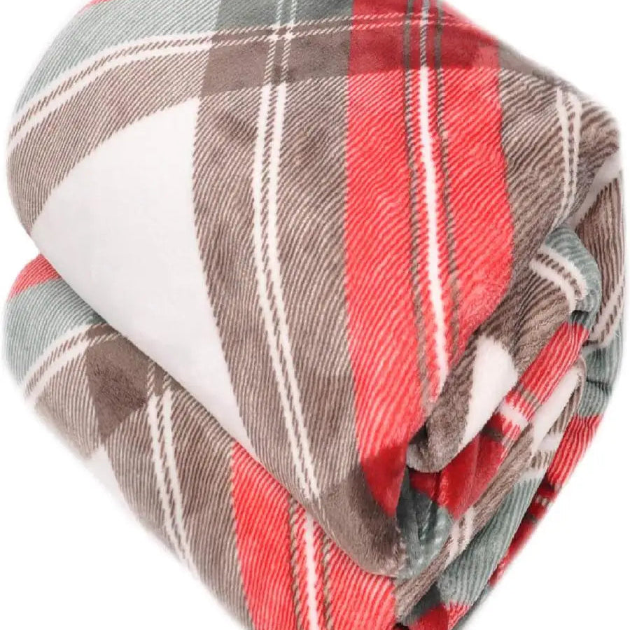 A folded red plaid blanket with red, brown, and white patterns on a white background
