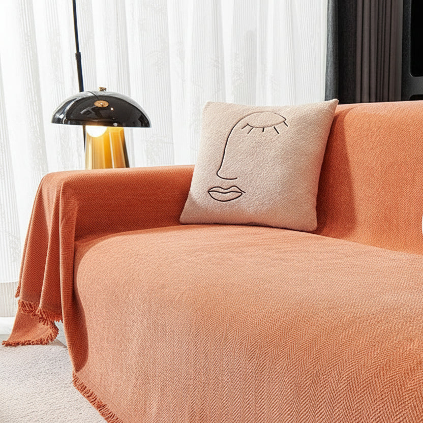 Close-up of Burnt Orange chenille sofa cover showing detailed herringbone weave and decorative pillow.