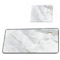 Two marble-patterned mouse pads with gold accents on a white background
