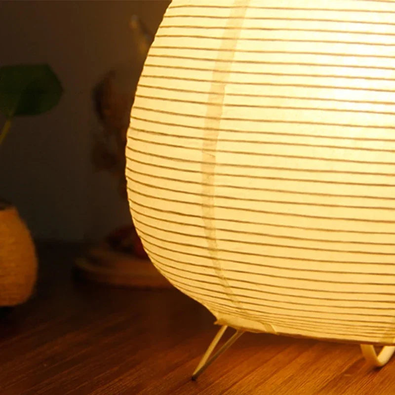 Round Japanese lamp on a wooden floor with a warm glow