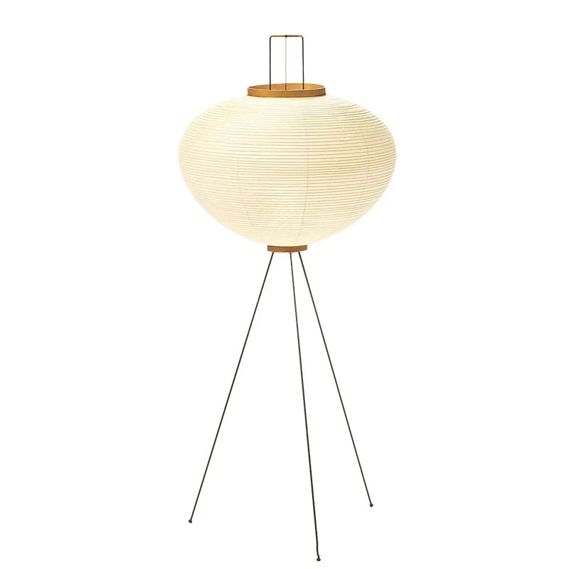 A Japanese floor lamp with a round paper shade and wooden top on a white background