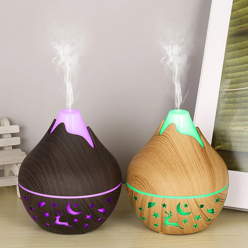 Two wooden diffusers with purple and green accents on a light surface.