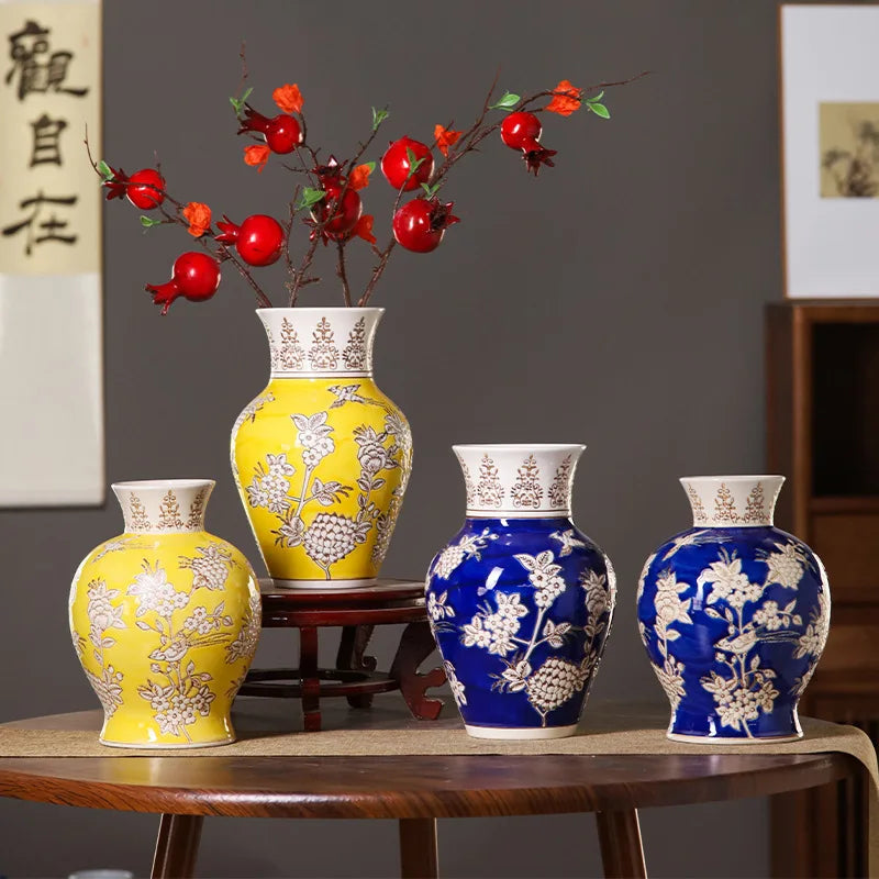 Set of four decorative vases with floral patterns on a wooden table.