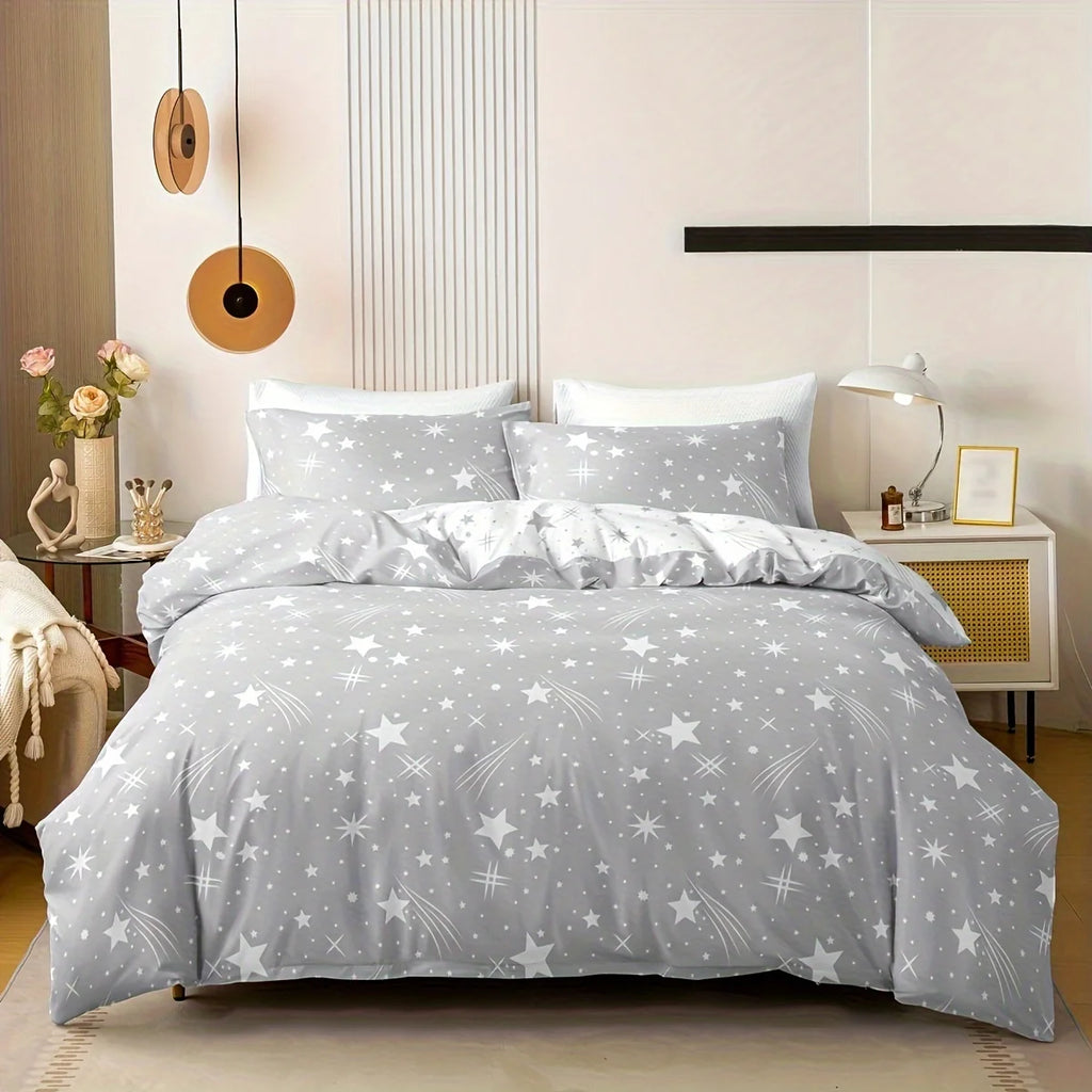 A grey star-patterned bedding set on a bed in a bedroom with decor elements.