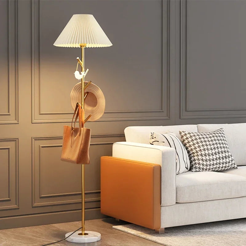 Gold metal floor lamp with marble base and integrated hooks