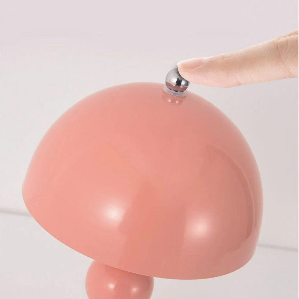Pink lamp with a touch switch button on a light gray background