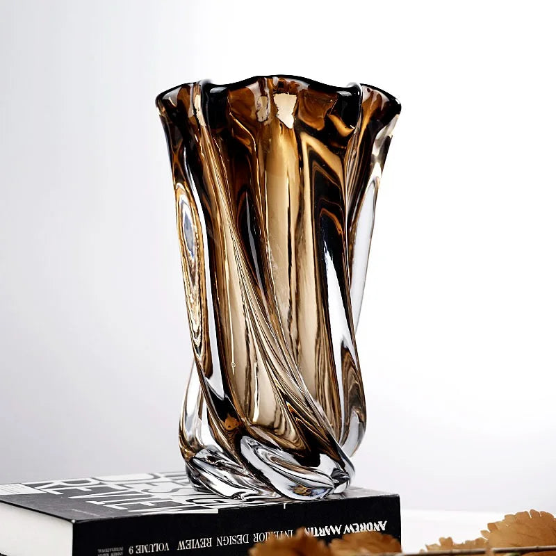 Decorative glass vase with brown and clear swirl design on a white background
