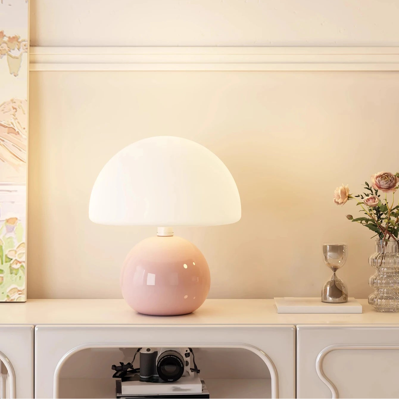 Pink table lamp on a white surface with a neutral background
