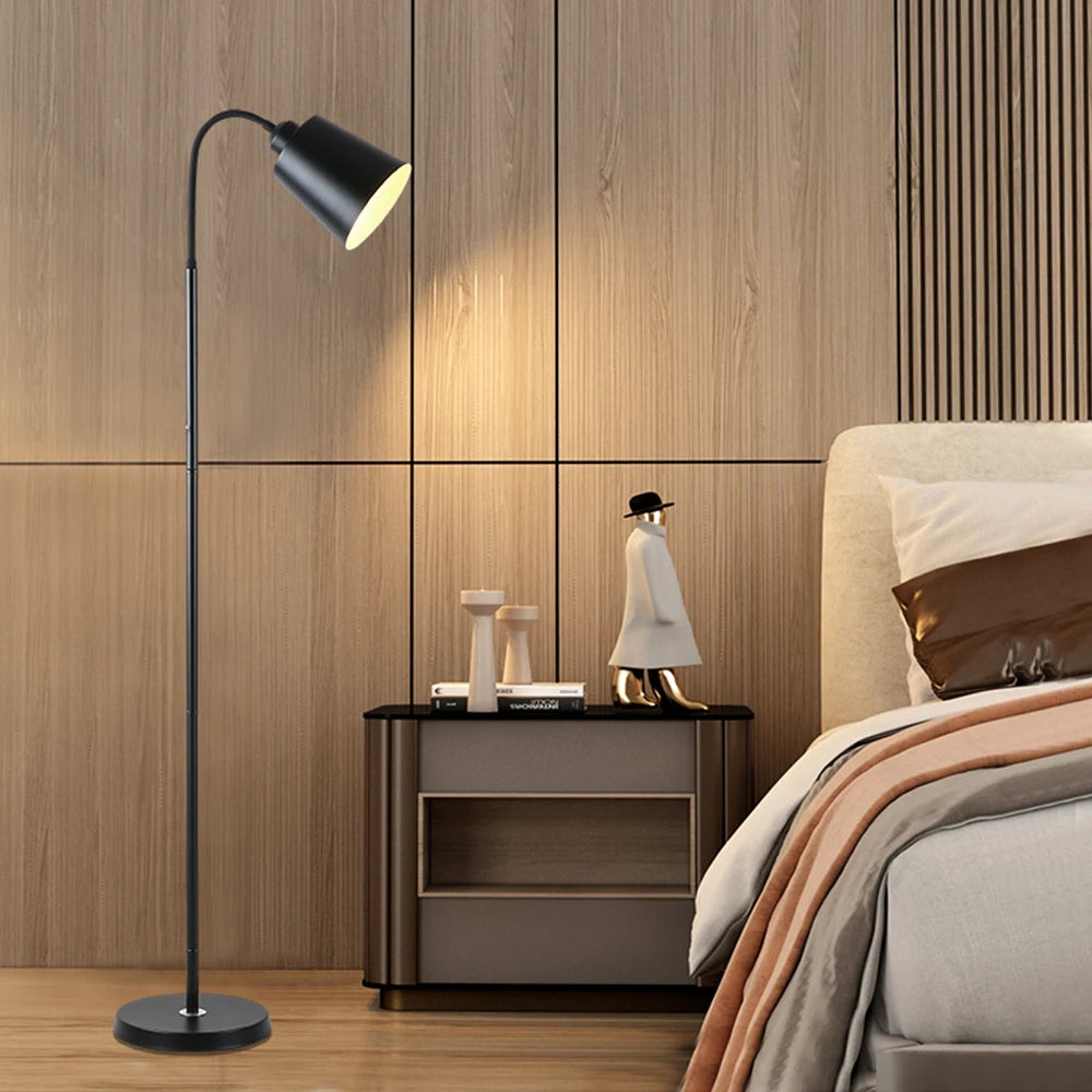 Modern bedroom with a floor lamp, nightstand, and bed.