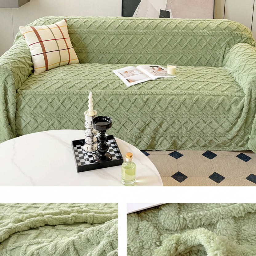 Green textured sofa cover with decorative pillows and a small table in a living room setting.