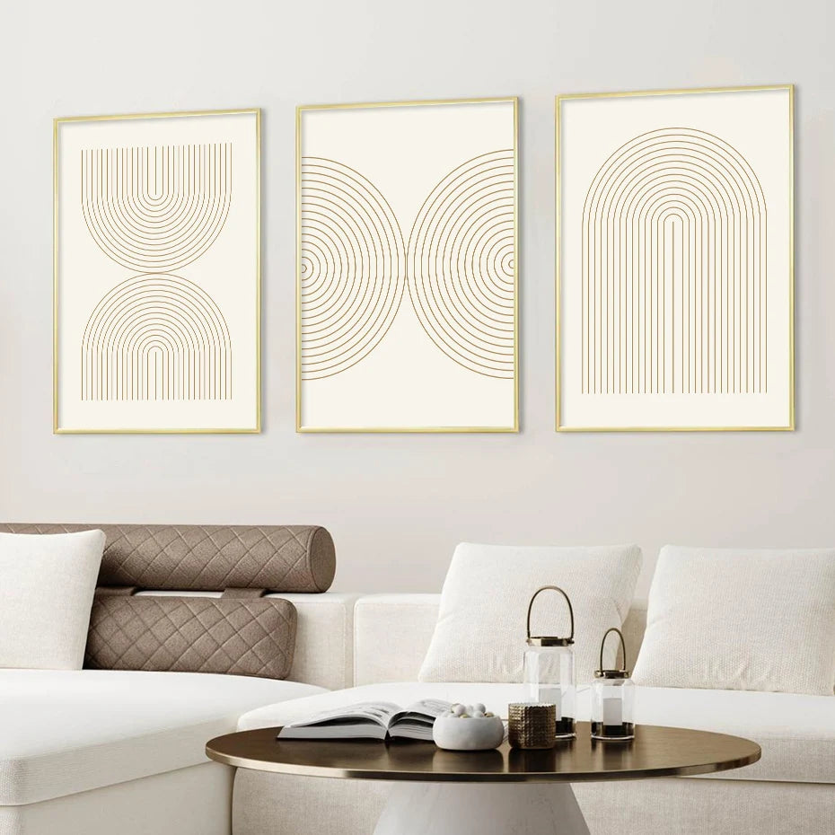 Three abstract wall art pieces on a white wall above a sofa.
