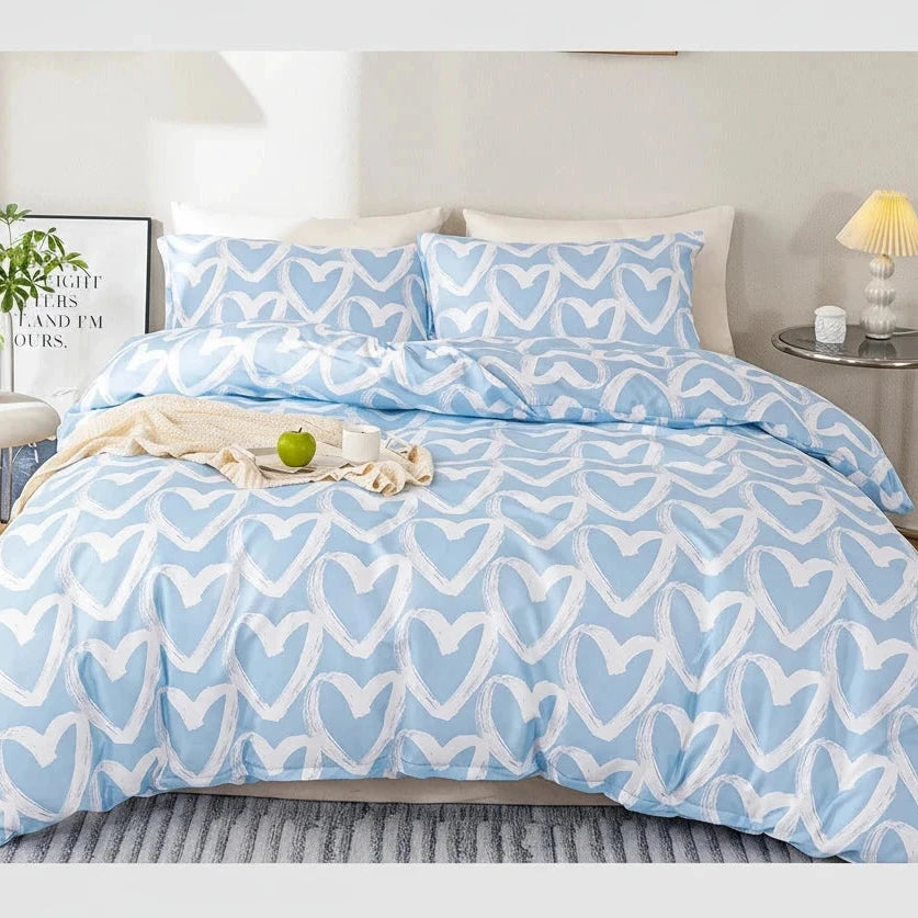 Blue and white patterned bedding set on a bed in a bedroom setting.