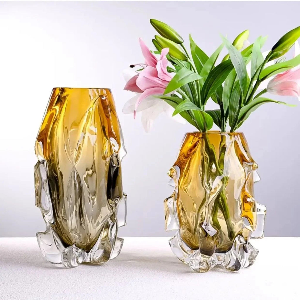 Side-by-side comparison of small and large modern amber glass vases with lilies.