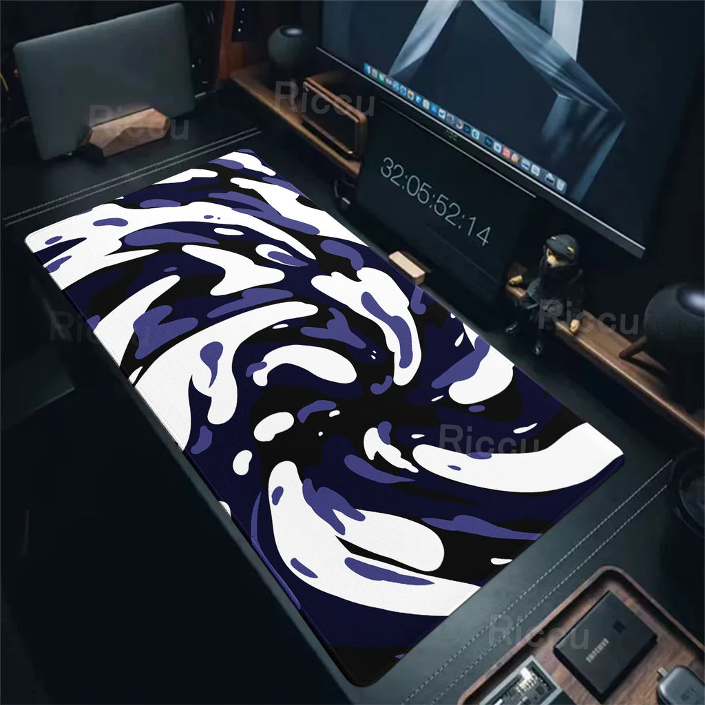 Desk mat with blue and white abstract design on a desk