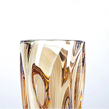 Sunset amber crystal glass vase featuring a rich golden gradient and spiralled texture.