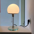 Mushroom table lamp with frosted glass shade and polished chrome body,