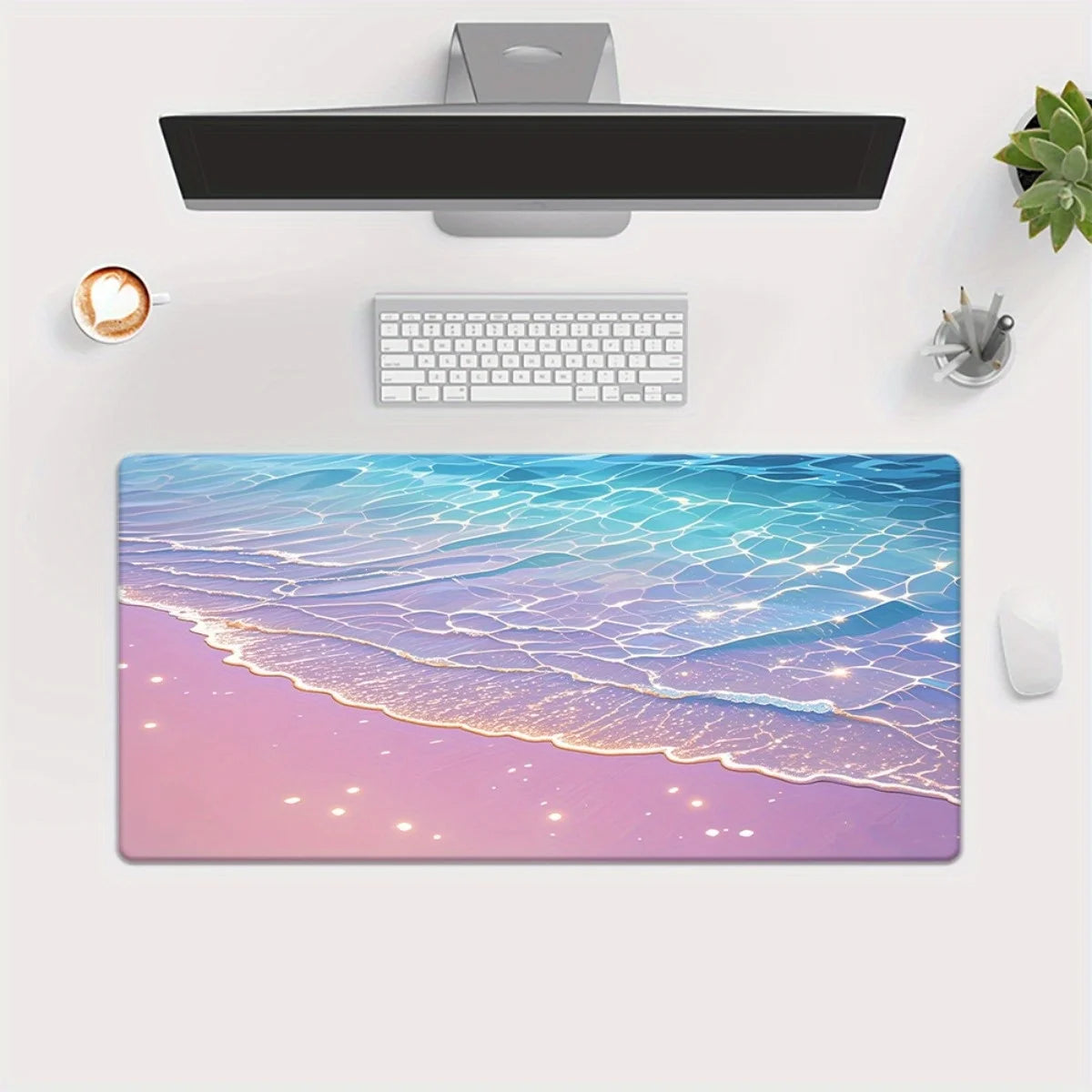 Desk setup with a large desk mat featuring a beach design, keyboard, mouse, and computer monitor.