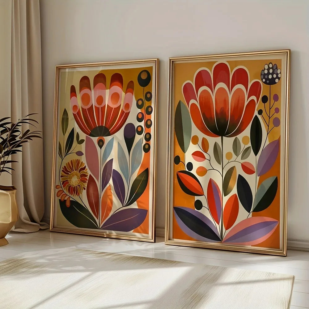 A pair of large unframed abstract floral canvas prints in gold frames leaning against a white wall.
