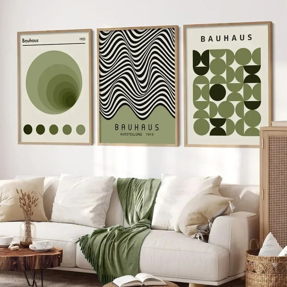 Bauhaus-themed posters on a wall above a white sofa with green accents.
