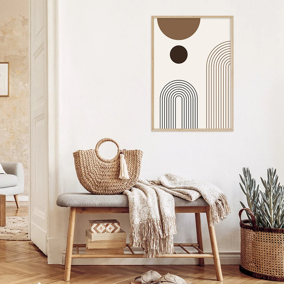 Decorative poster on a wall above a bench with a woven bag and blanket.