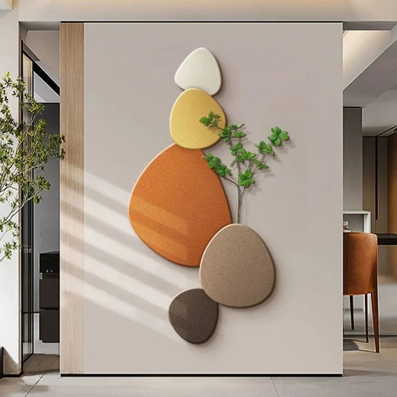 Decorative abstract LED wall light with warm pebble shapes and soft backlighting on a modern wall.
