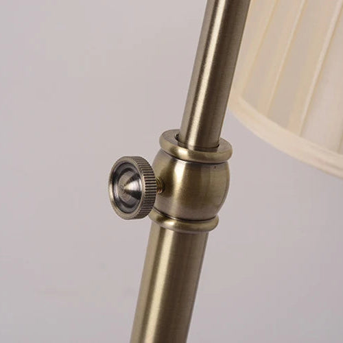 Close-up of adjustable height fitting on antique metal-look floor lamp.