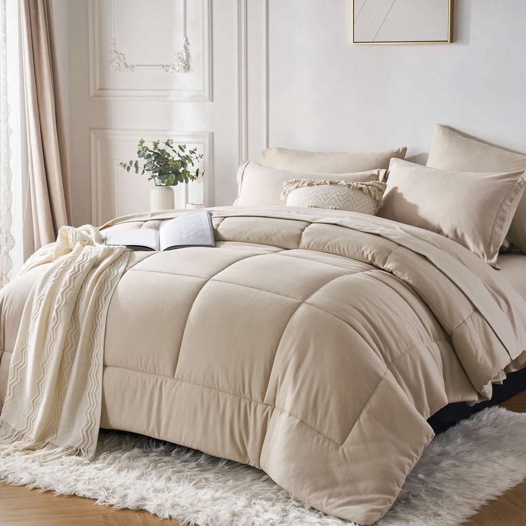 Beige comforter set on a bed in a bedroom with light decor