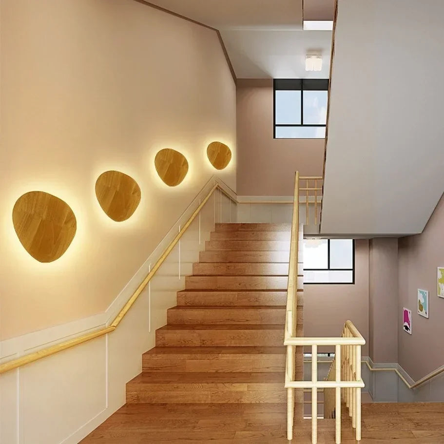 Oval wooden LED wall lights.