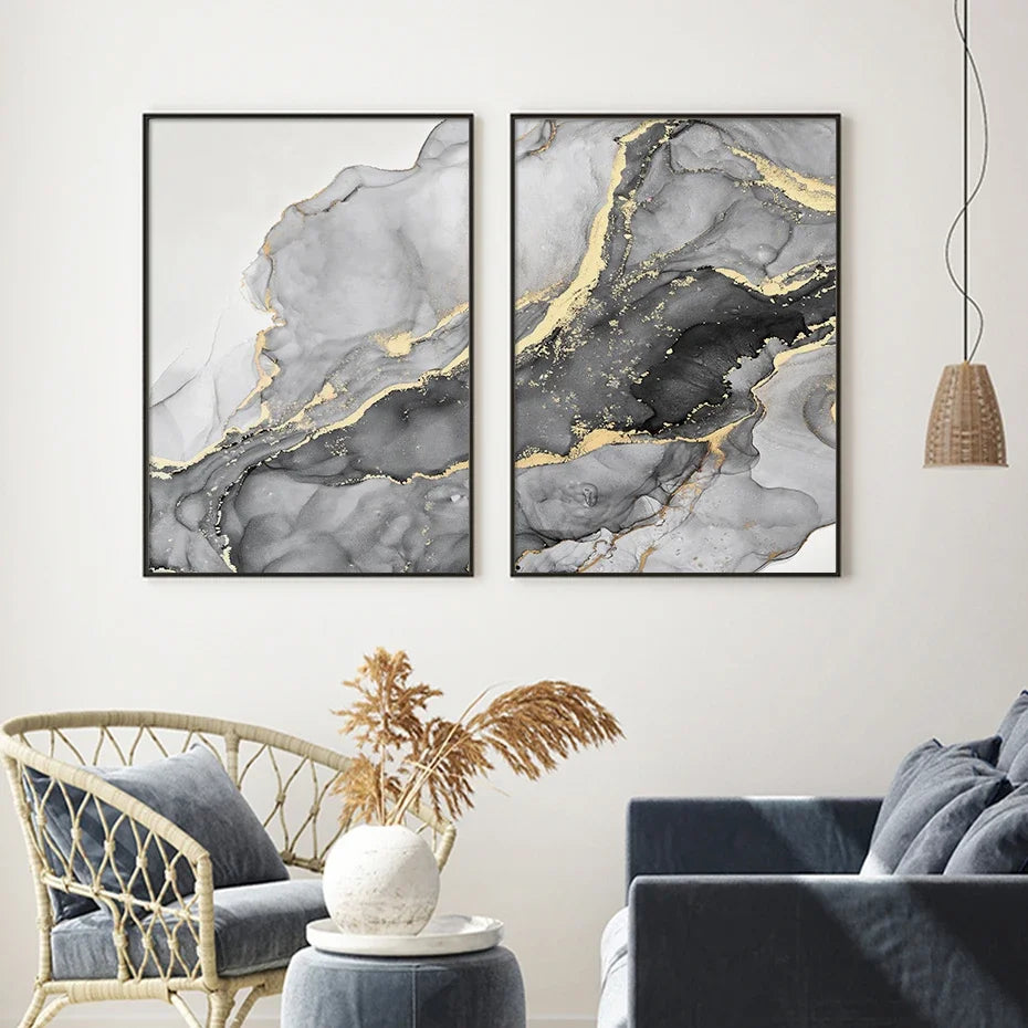 Two abstract art pieces in black frames on a wall above a sofa and chair.
