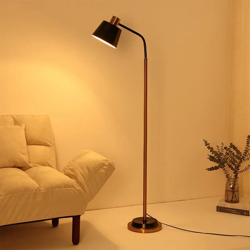 Black arc floor lamp beside a cream sofa in a bright living room