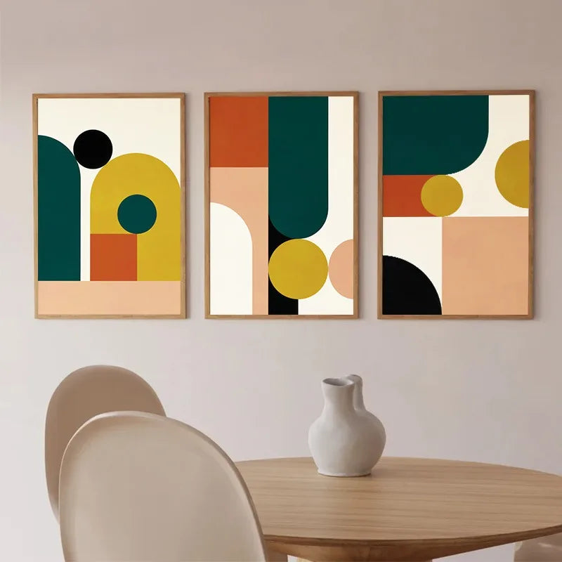 Styled wall art set featuring three abstract geometric canvas prints in green, mustard, rust, blush, and black tones