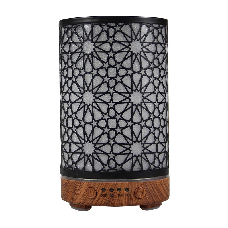 Black metal star-patterned diffuser with a dark wood-grain base for aesthetic desk setups.