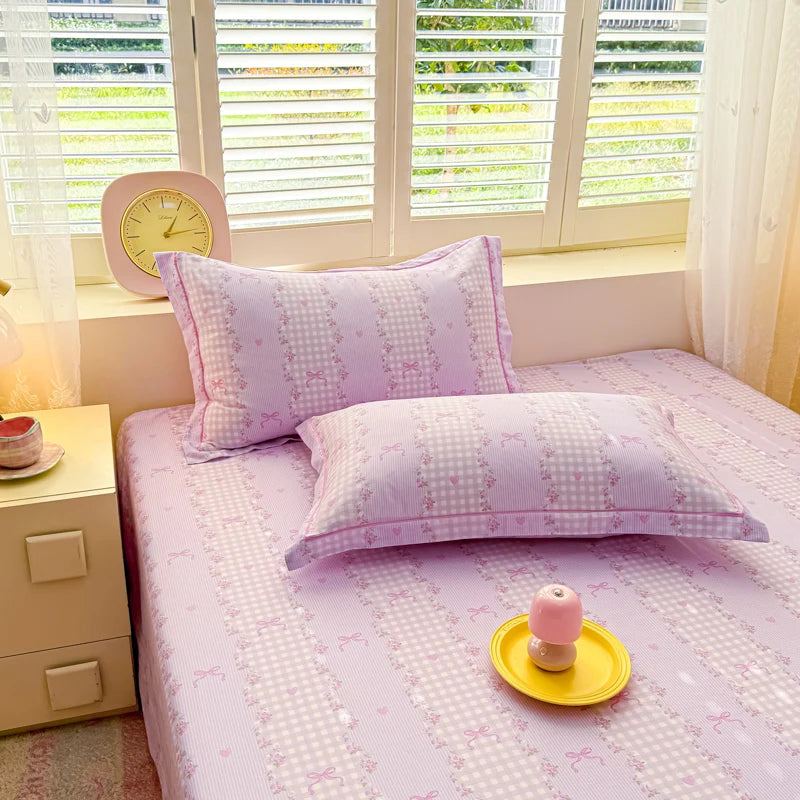 Close-up of Purple Gingham cotton duvet cover featuring lavender checks, pink bows, and floral borders.