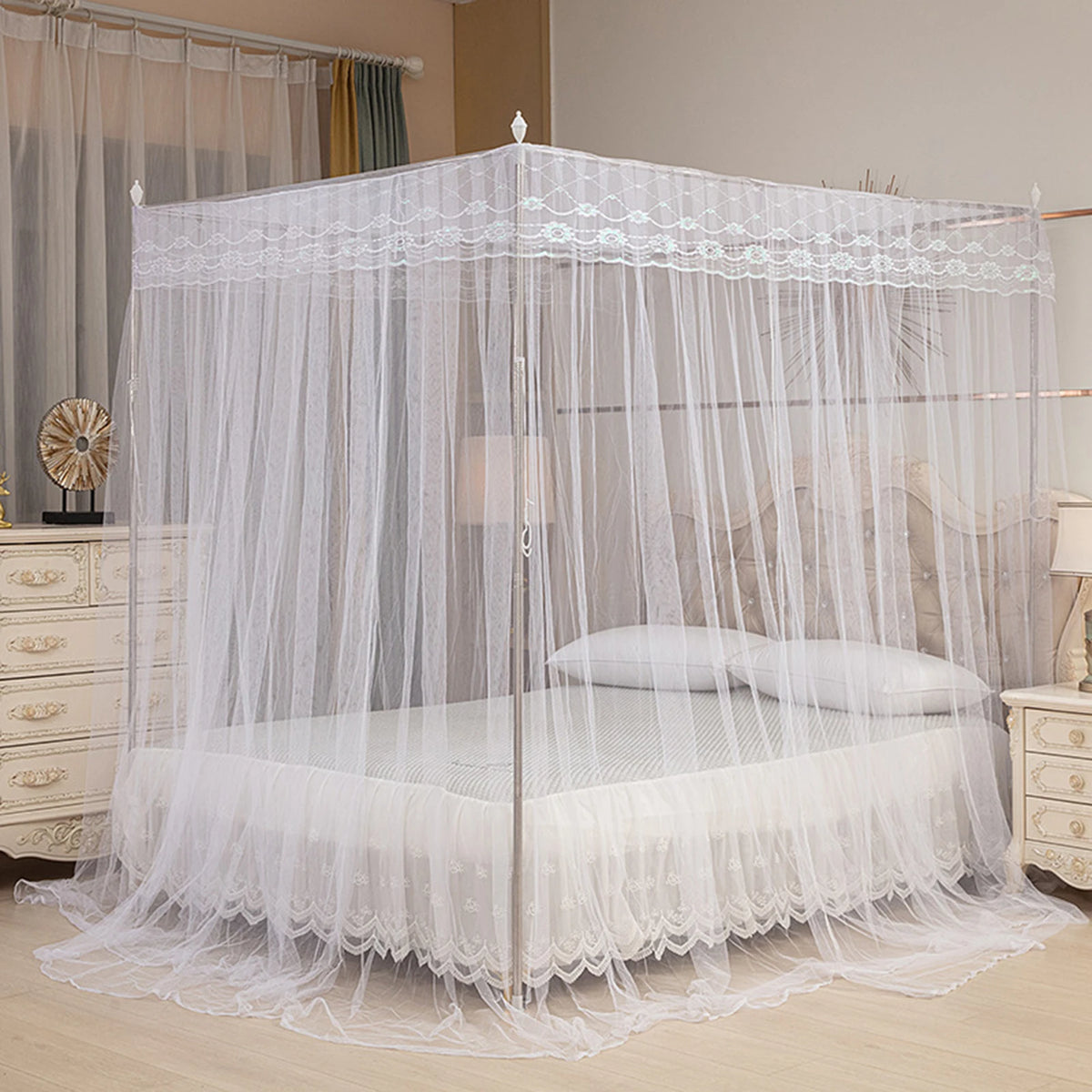 White four-poster lace canopy mosquito net draped over a bed.