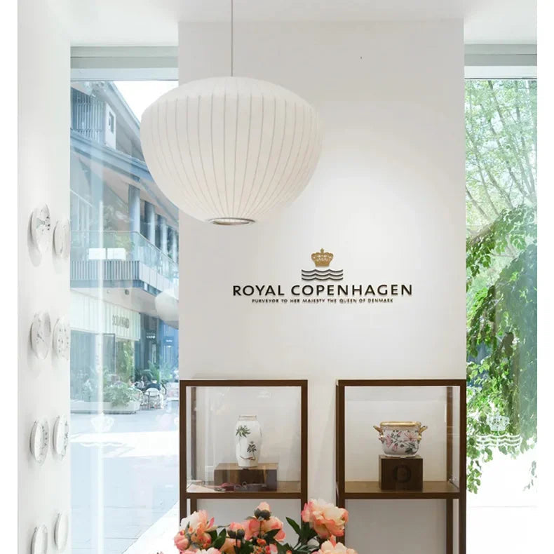 White Wabi Sabi pendant lamp hanging above a styled dining display