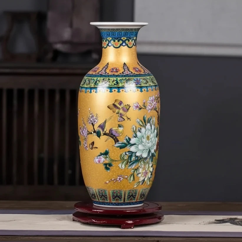 Decorative vase with floral and butterfly design on a wooden surface.