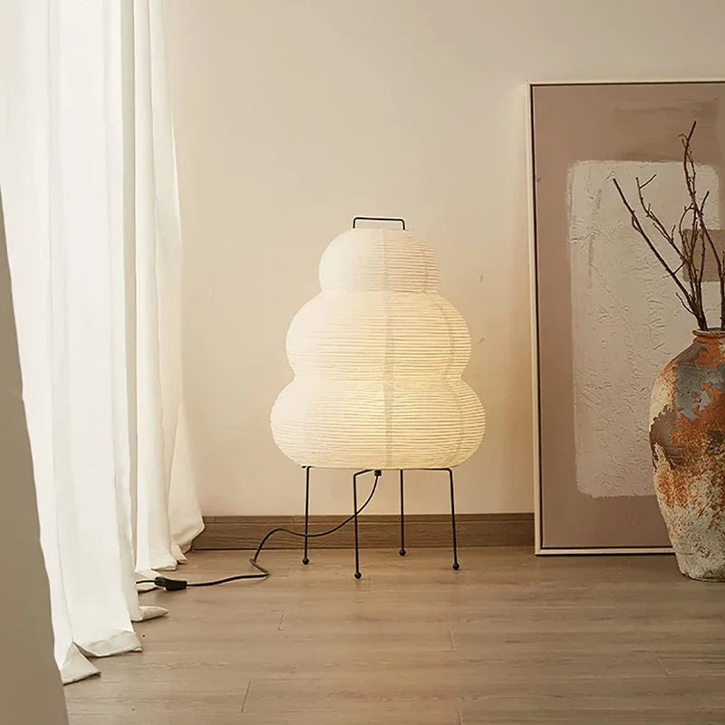 A modern floor Japanese lamp with a unique design in a room setting.