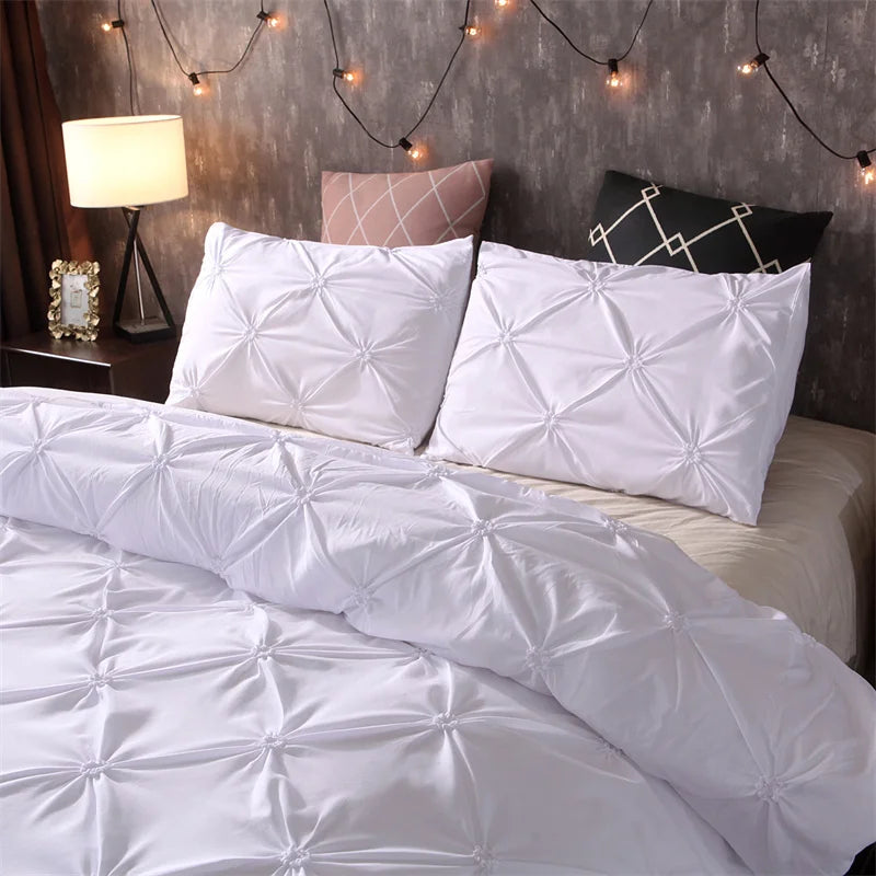 White pintuck duvet set with matching pillowcases dressed on a double bed in a warm contemporary bedroom