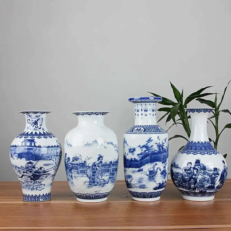 Set of four blue and white ceramic vases on a wooden surface with a plant in the background.