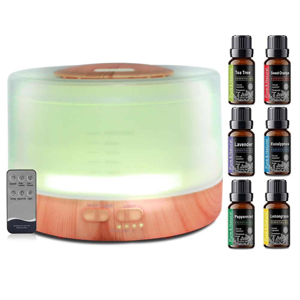 Aromatherapy diffuser with a remote control and various essential oil bottles on a white background