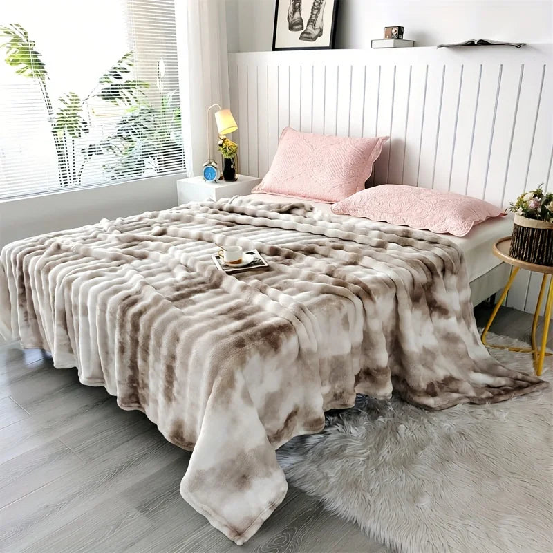 Beige and brown patterned blanket draped over a bed in a bright bedroom.