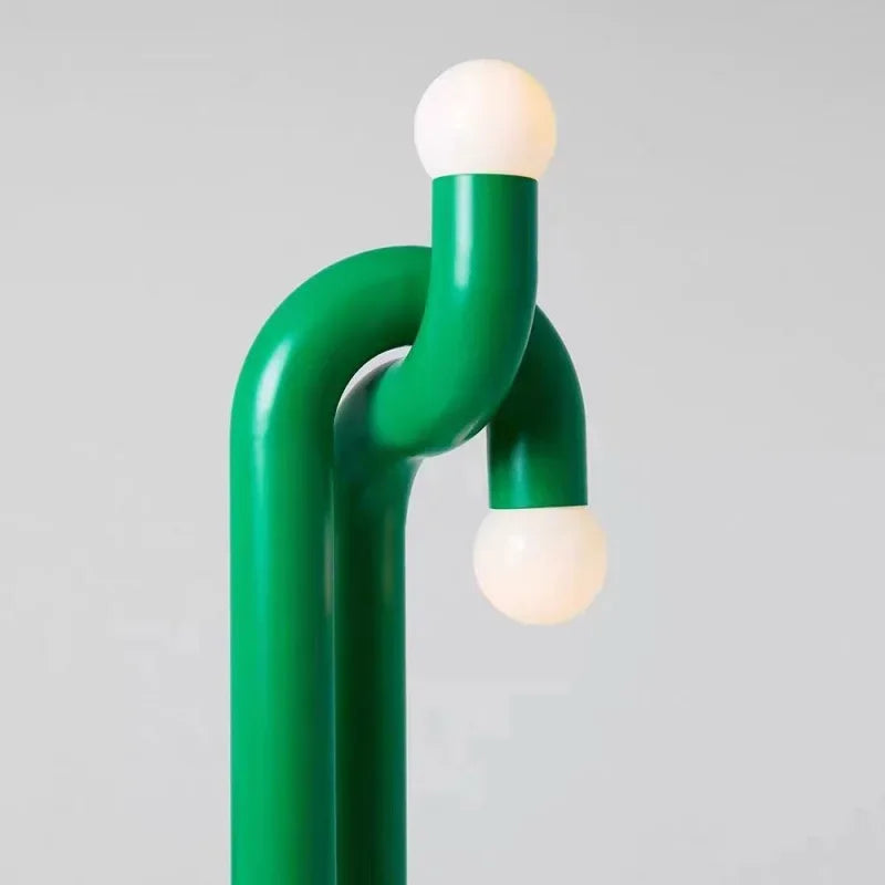 Modern green lamp with two light bulbs on a gray background
